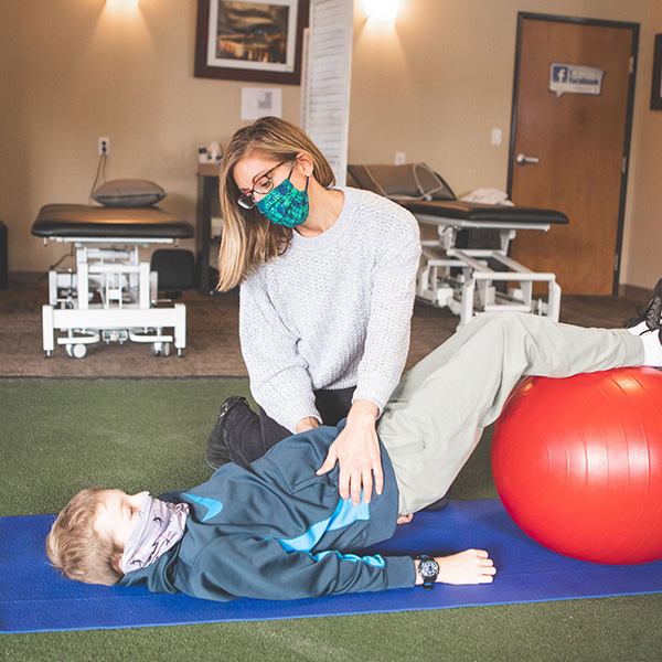 pediatric physical therapist works with a young patient