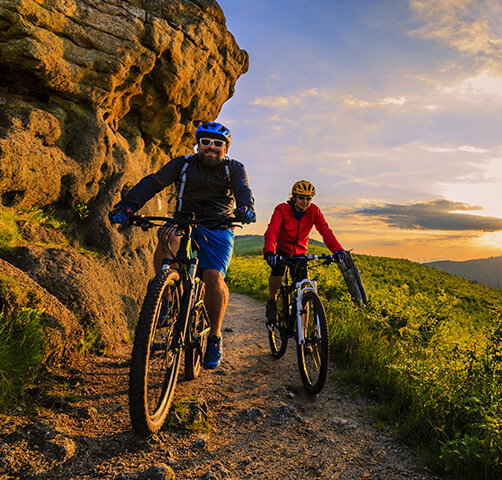 Man and woman biking outdoors