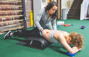 physical therapist assesses a patient's spine
