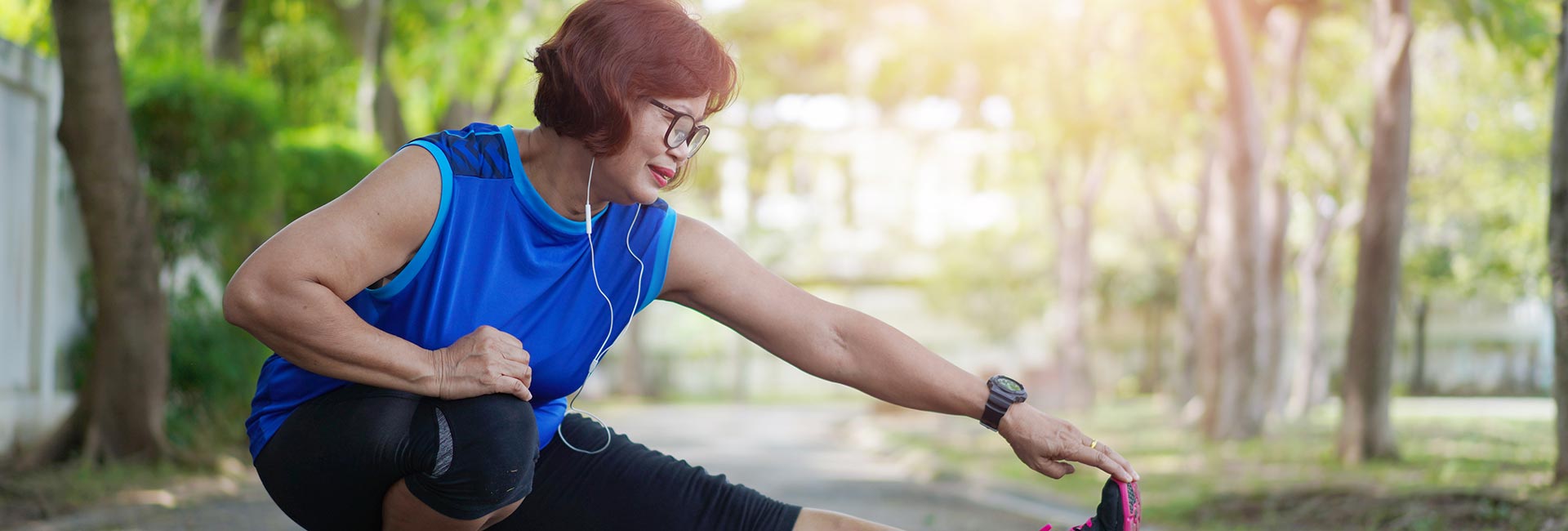 a woman stretches out on a trail - exercise