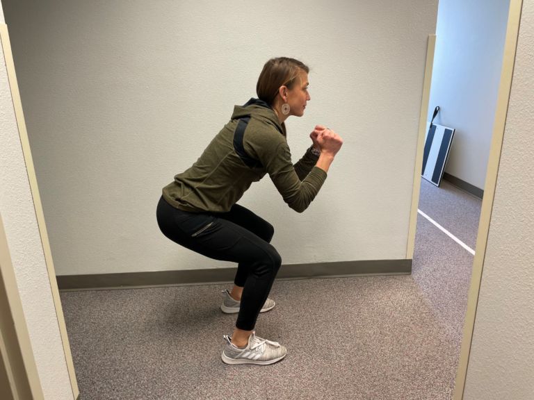 demonstrating good squat form