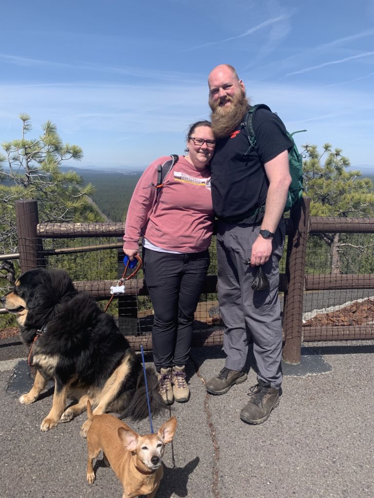 Sara and Kevin Borquist with their dogs on a hike