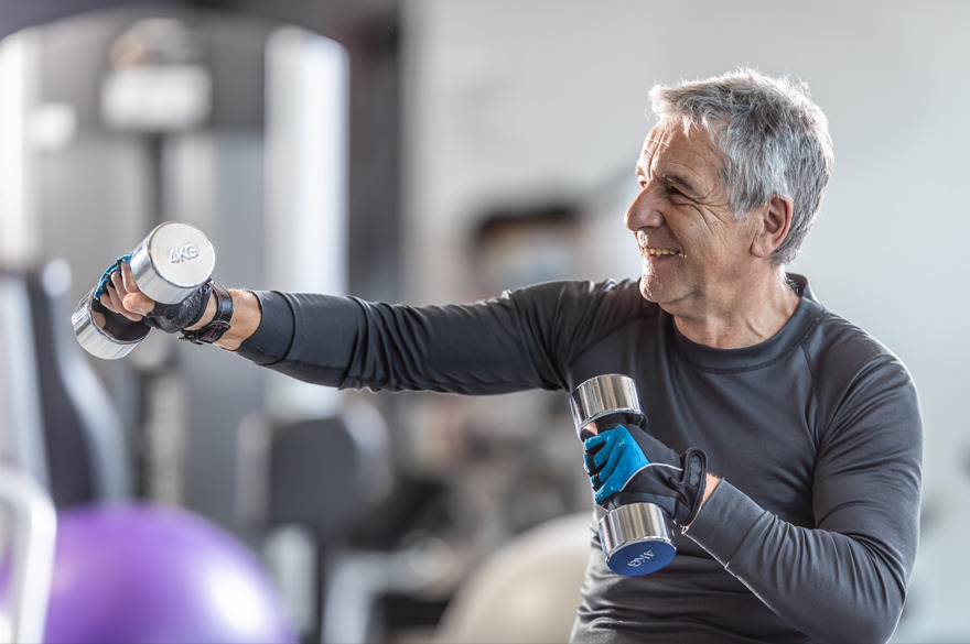 older man works out with weights