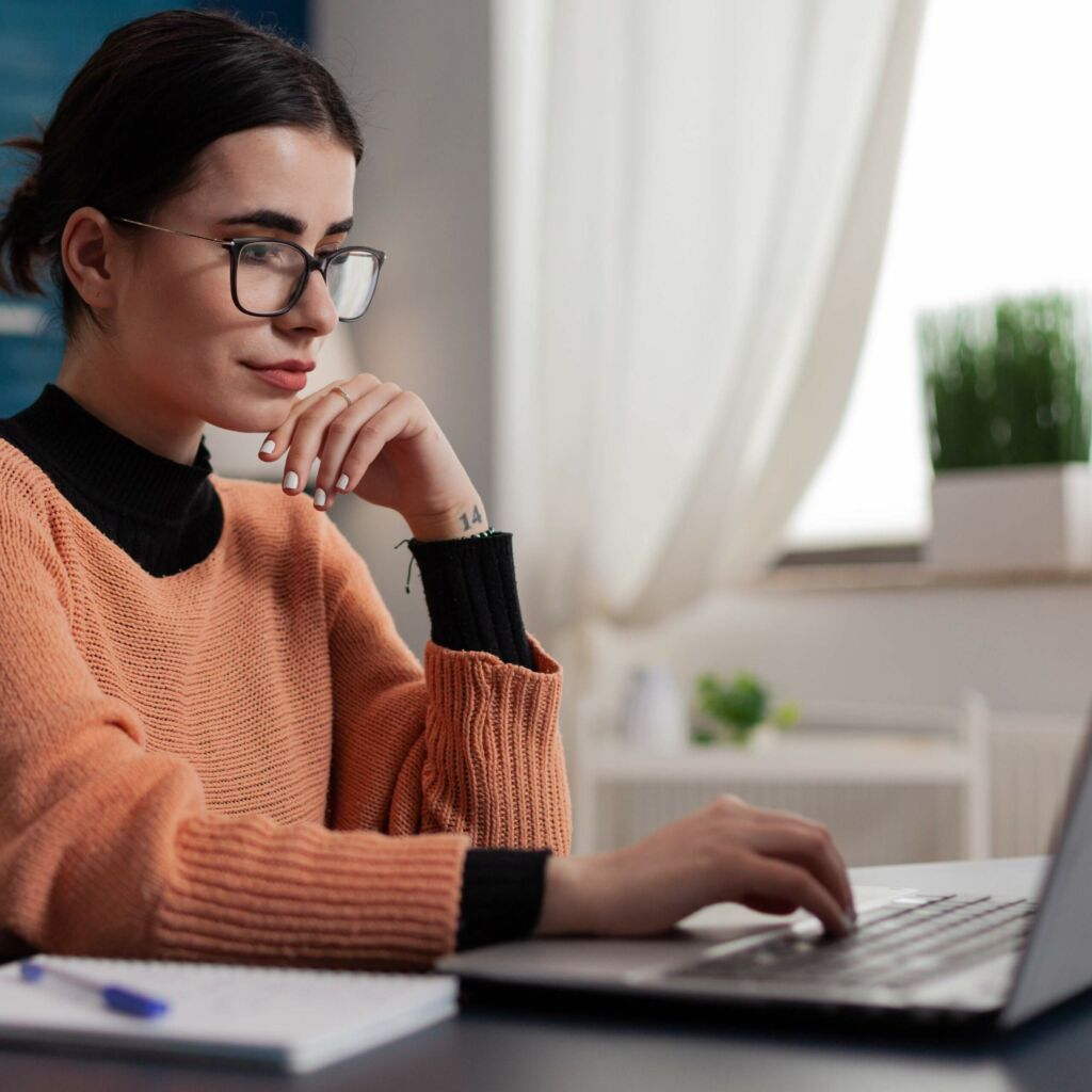 woman works at a laptop using proper ergonomics