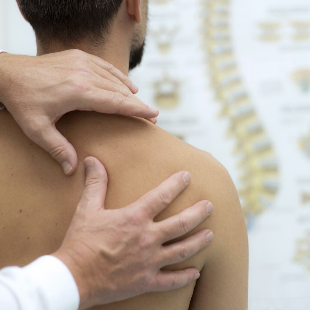 medical provider assesses patient shoulder