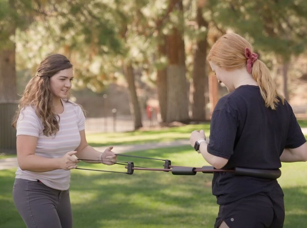 physical therapist works with patient outdoors