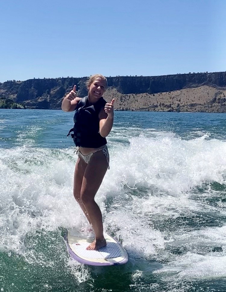 happy girl enjoying wake surfing on a lake