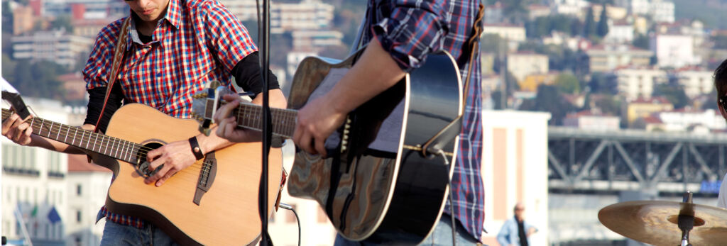 guitar players perform rooftop concert