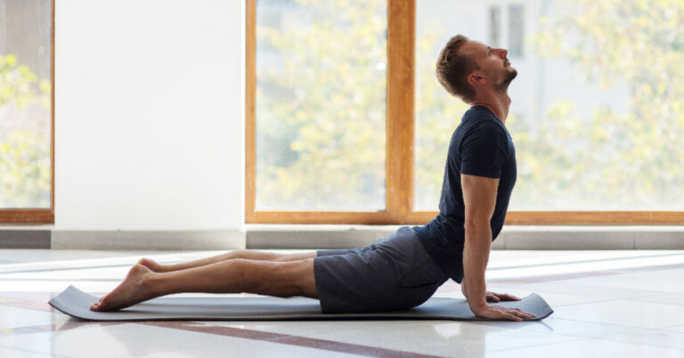 man holds Cobra Pose to stretch low back