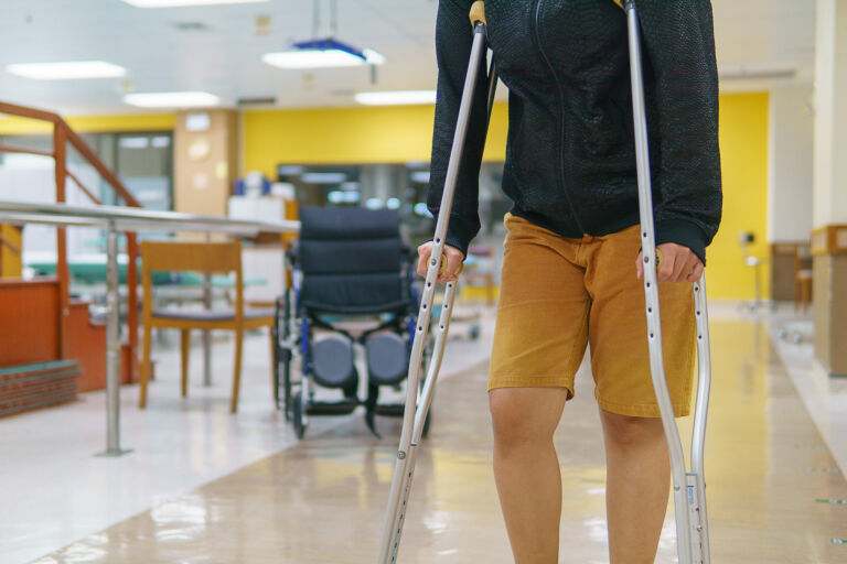 A person leans on crutches