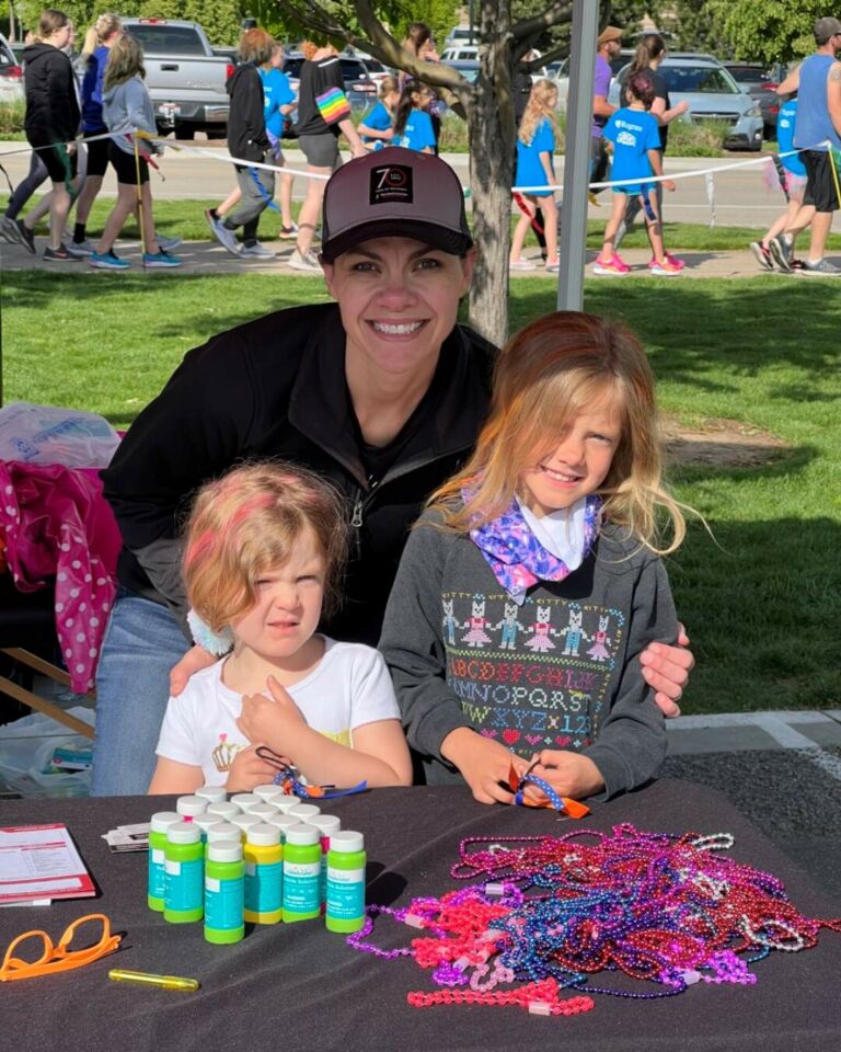 PT Mindy English and her daughters at the Therapeutic Associates Eagle sponsorship tent for Girls on the Run.