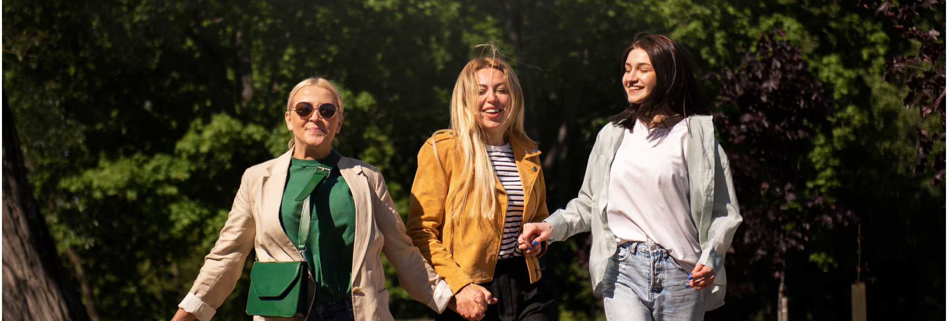 three women smiling happy on a walk together spring weather outdoors