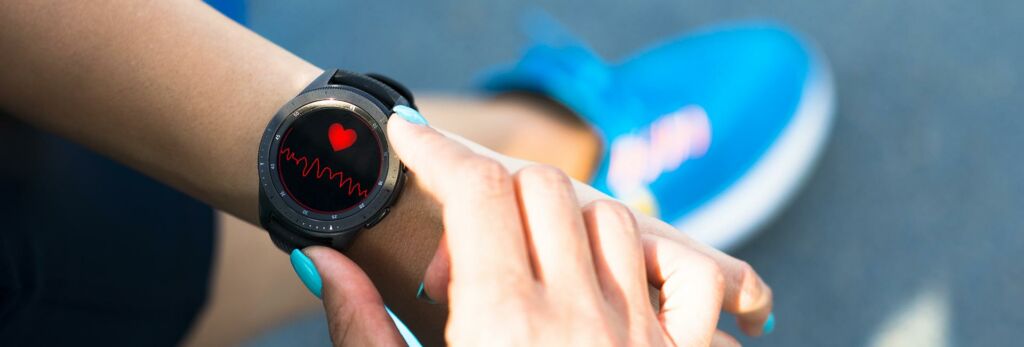a person checks their heart rate on fitness watch