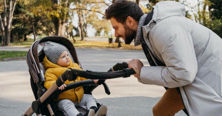 A dad out on a walk with child in a stroller