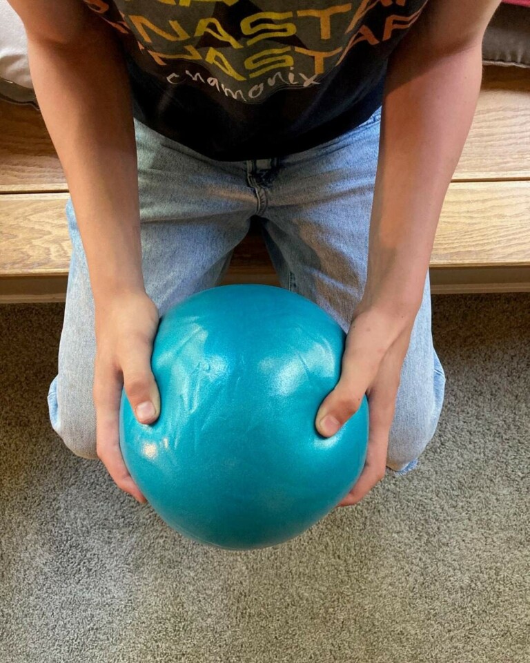 using a Pilates ball to work on hand strength