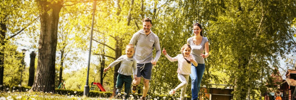happy family outdoors running and being active together