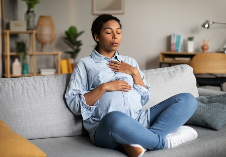 a pregnant woman works on breathing exercise