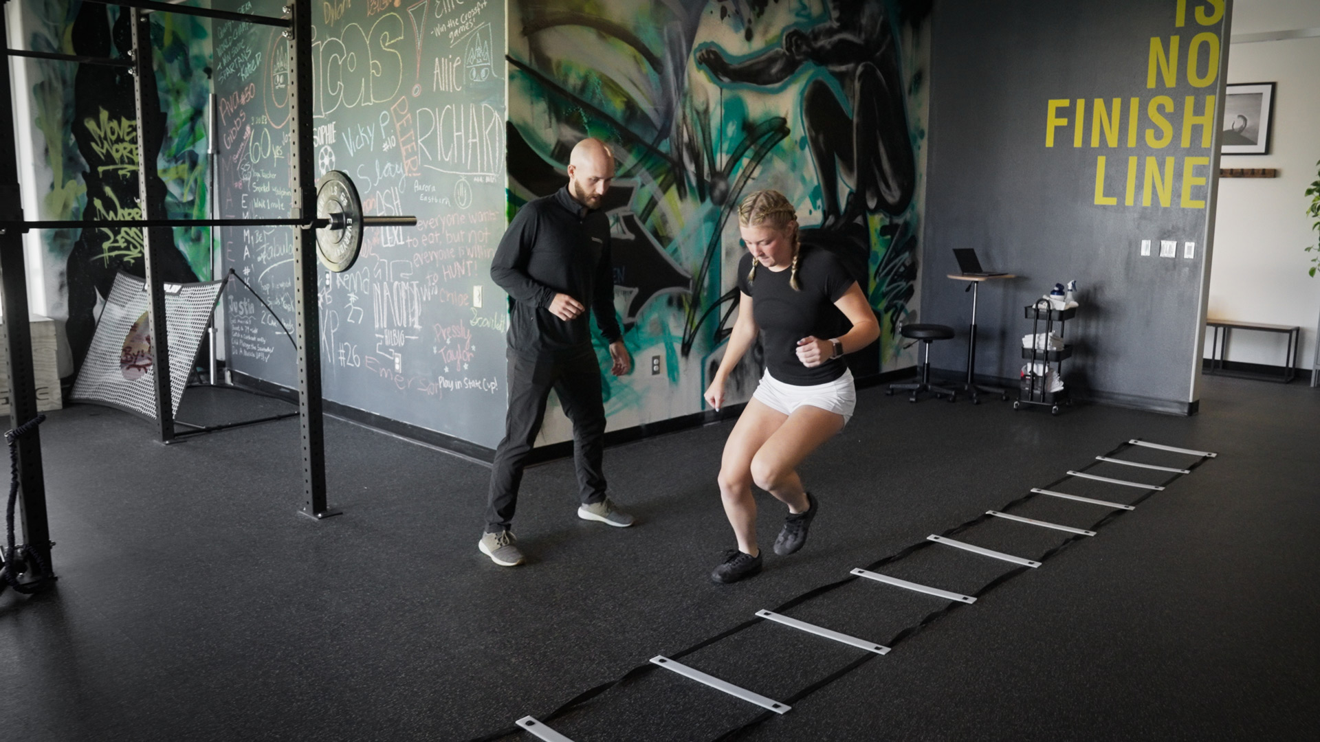 physical therapist guides a young athlete in agility drills during a knee rehabilitation session in the clinic