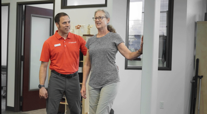 PT Brian Weiderman works with a patient in the clinic