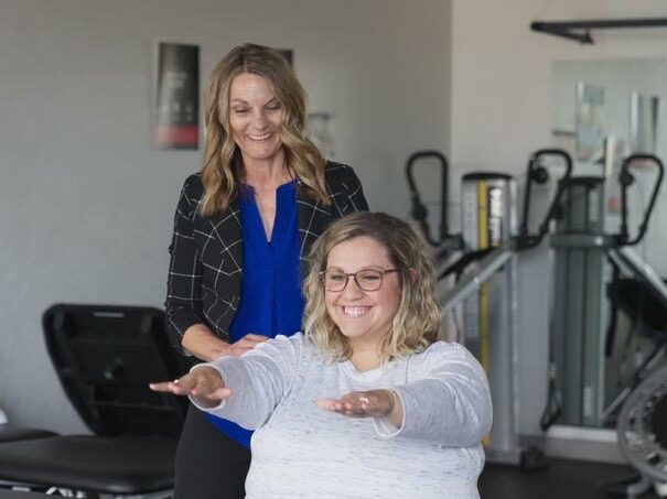 physical therapy assistant Lisa Holden Jackson assists a patient with exercises