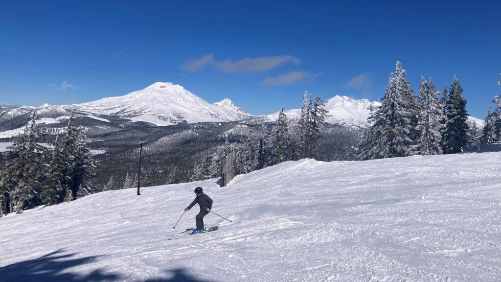 A skier enjoys a sunny day on Mount Bachelor.