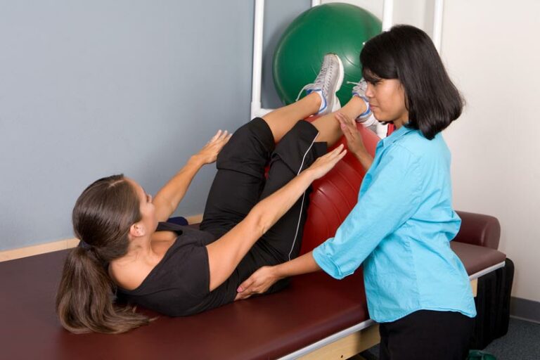 Physical therapist works with a patient on core strength