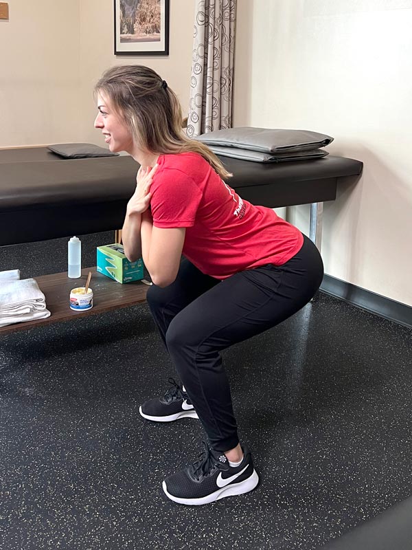 demonstration of a squat exercise