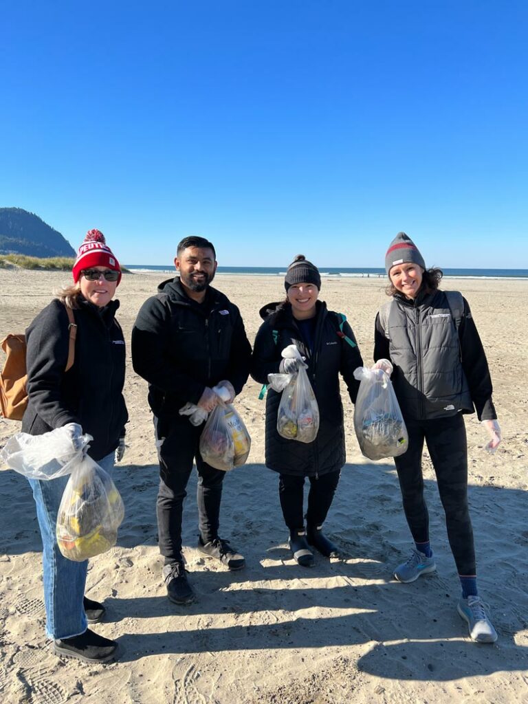 Team members from Therapeutic Associates Physical Therapy participate in a beach clean up with Ocean Blue for PT Day of Service 2023