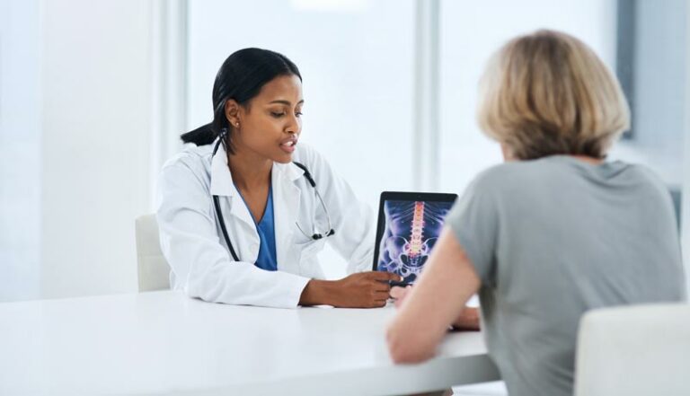 a doctor discusses an xray or DEXA scan with a patient facing osteoporosis
