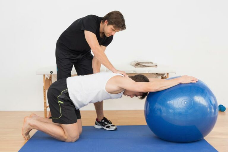 a physical therapist assesses a patient's back alignment