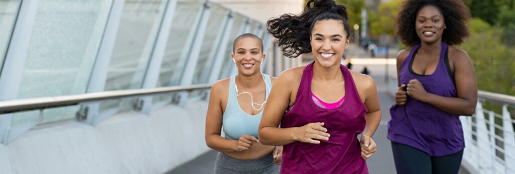 a group of three diverse women run for exercise and fun