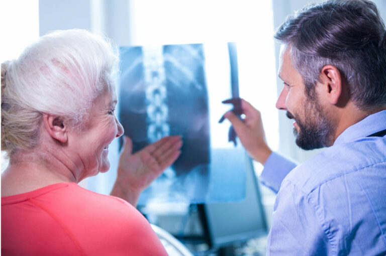 a medical professional discusses an Xray image with a patient