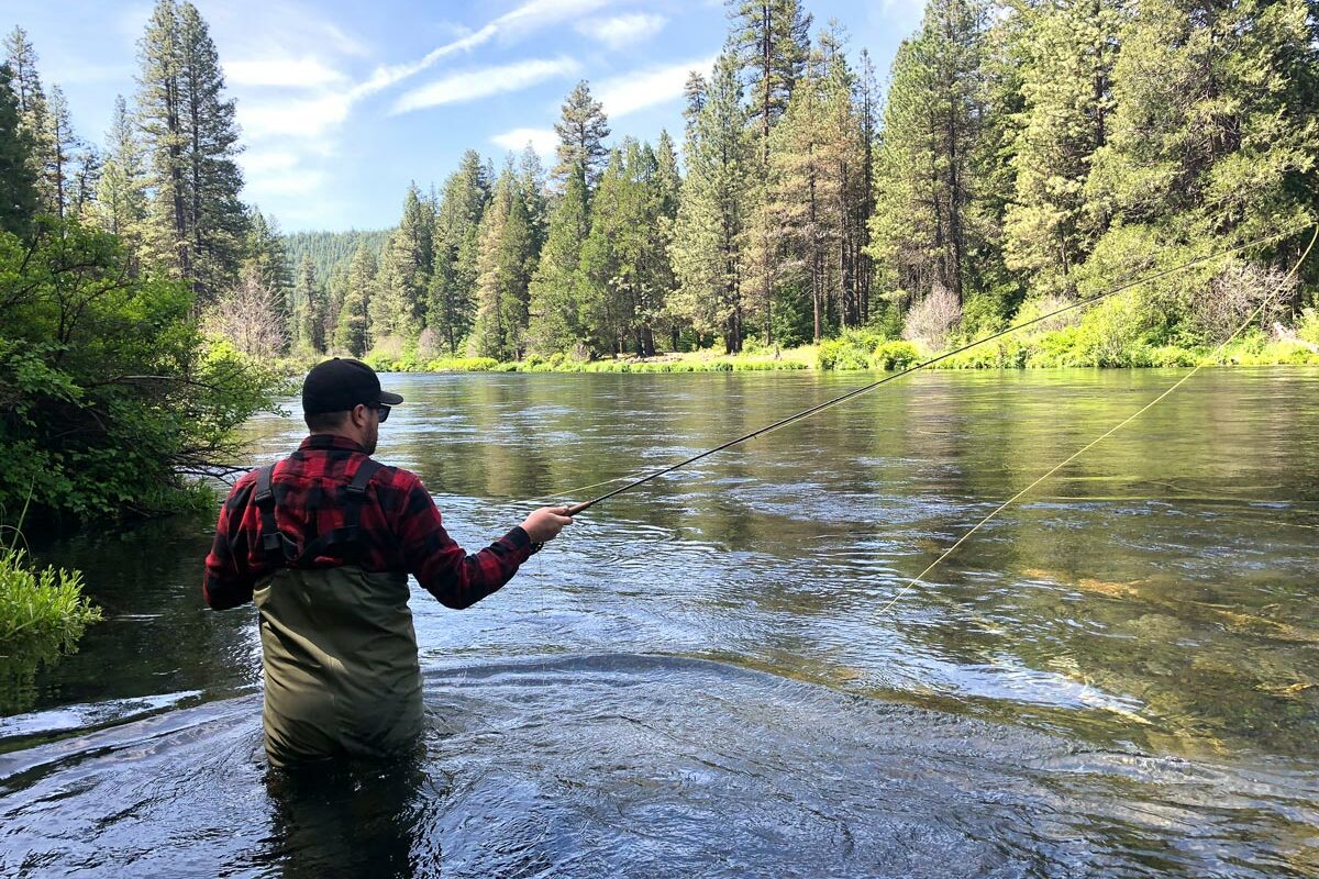 A man spends a quiet afternoon fly fishing in the Pacific Northwest
