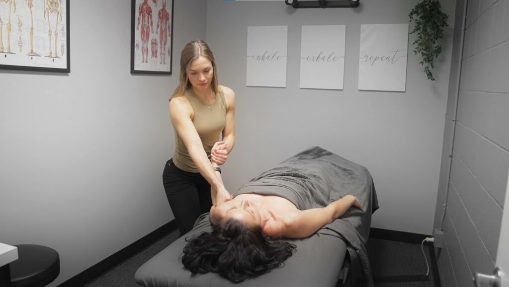 massage therapist Jocelyn Davis works with a PT patient