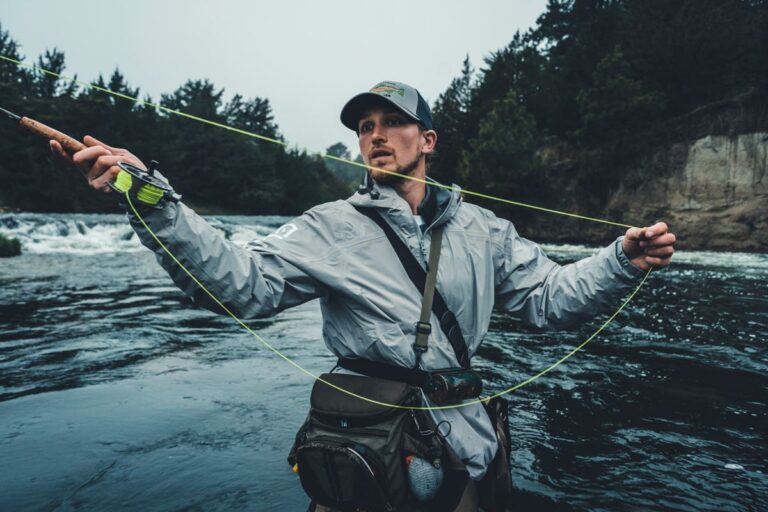 a man works his fly fishing pole and line for the perfect cast