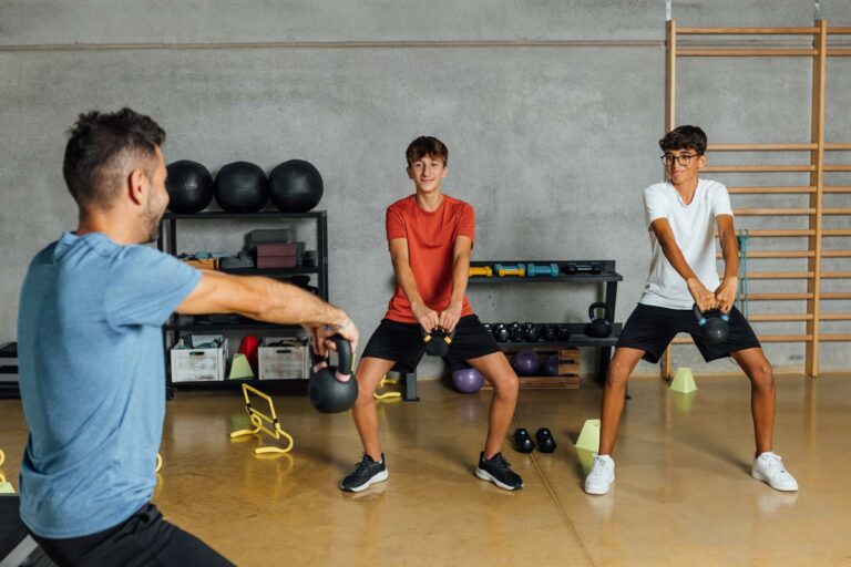teenagers using kettlebells for working out