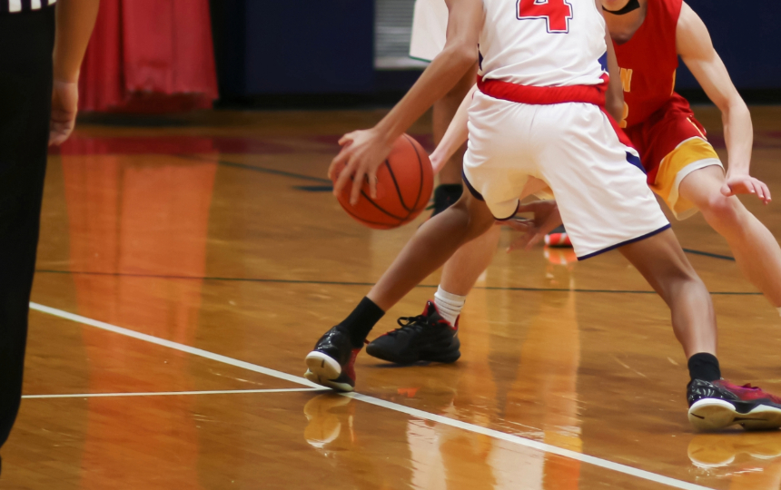 lower half of two opponents during a youth basketball game